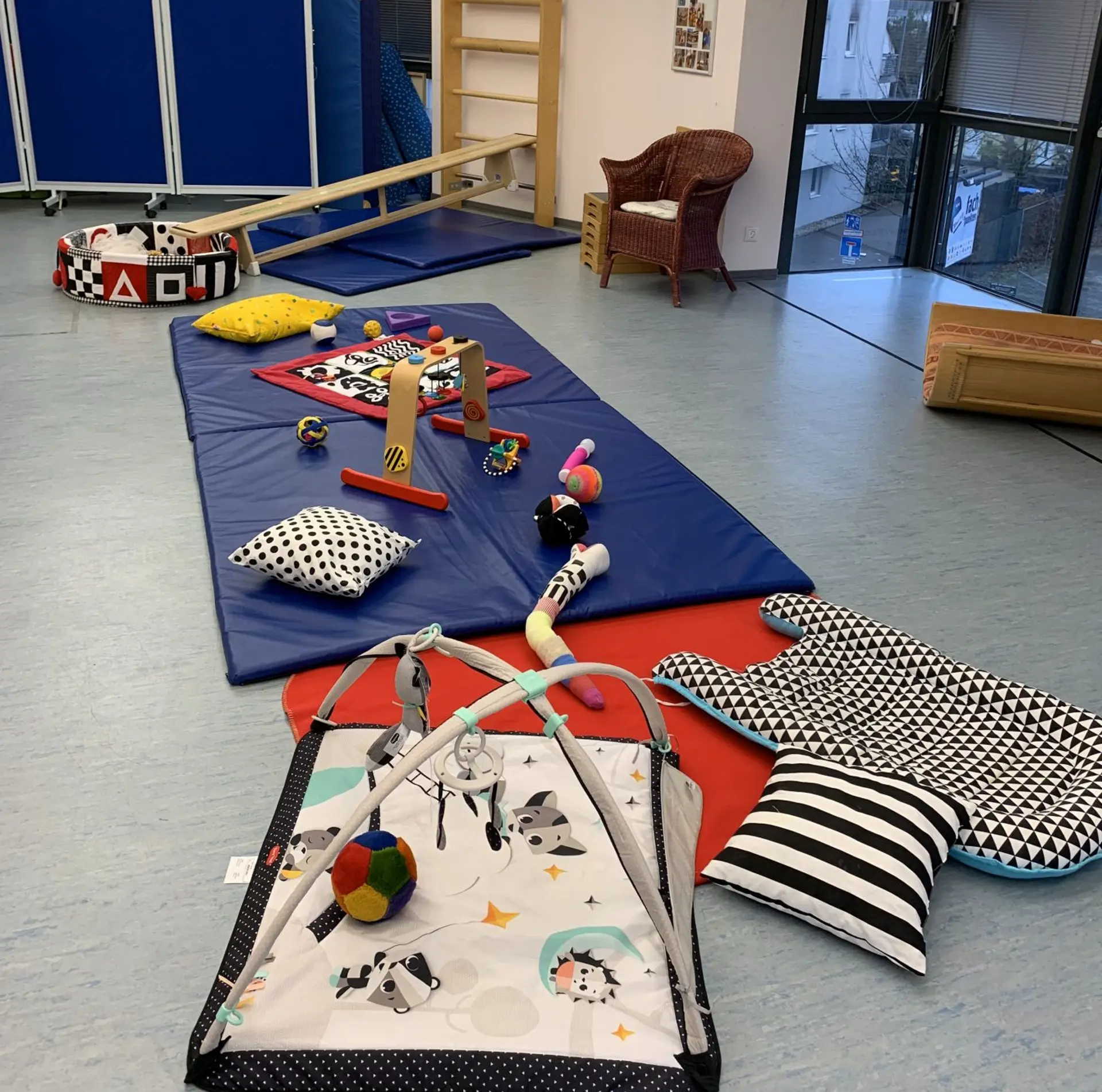 Im Bewegungsraum des Frühförderzentrums liegen kontrastreiche Spielmaterialien für Babys.