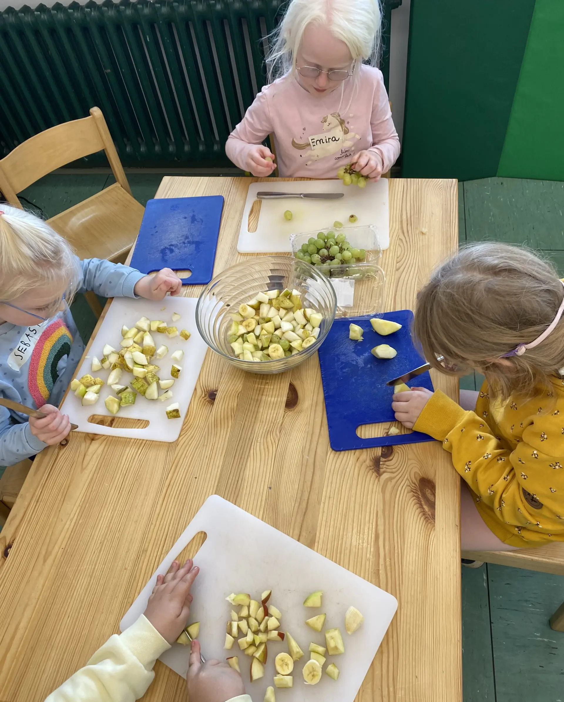 Schüler*innen bereiten einen Obstsalat zu 